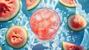 Watermelon juice in a glass with ice cubes photo