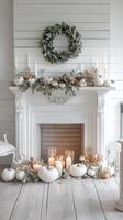 A white fireplace with candles and pumpkins photo