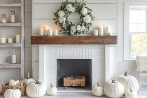 A white fireplace with pumpkins and candles photo