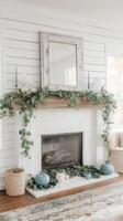 A white fireplace with greenery and pumpkins on it photo