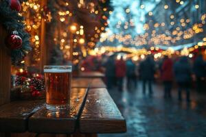 A beer is sitting on a wooden bench in front of a christmas market photo