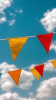 A colorful bunting with a blue sky in the background photo