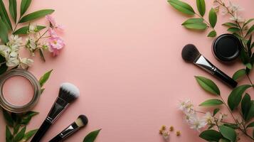 Makeup brushes and flowers on a pink background photo