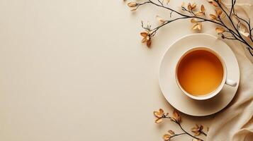 Cup of tea on a white background with a branch of flowers photo