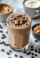 Coffee and peanut butter smoothie in a glass photo