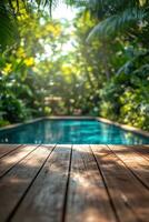 Wooden deck with pool in tropical jungle photo