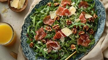 A salad with prosciutto, arugula and walnuts photo