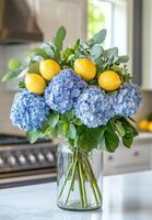 A vase filled with blue and yellow flowers photo