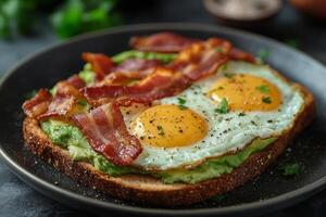 Avocado toast with eggs and bacon photo