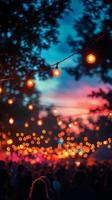 A crowd of people at an outdoor event with string lights photo
