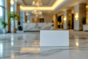 Blank card on marble table in lobby of hotel photo