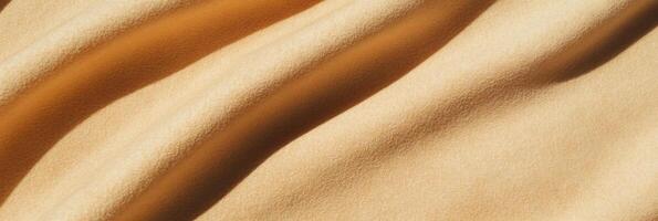 Soft beige suede texture with subtle shadows highlighting warm light play photo