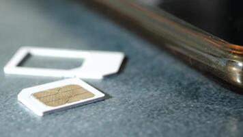 Inserting a SIM card into a smartphone at a desk video