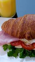 Croissant with jamon ham, Salmon, in Modern Cafe, Top View of Healthy Breakfast in Cafe. English breakfast. fried egg, bacon toast on sandwich. video