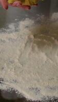 Hands kneading dough on a countertop with scattered flour and ingredients. video