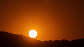 The sun is setting over a hill video