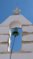 Church bell ringing belfry bright white stone with cross on top, has electrical mechanism instead of a rope. video