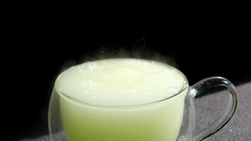 fizzy citrus cocktail in a glass bubbling and releasing many air bubbles in the glass. Effervescent tablet with citrus flavor. aspirin dissolving process. Carbonated drink video