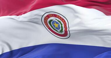 Paraguay flag waving at wind with blue sky in slow, loop video