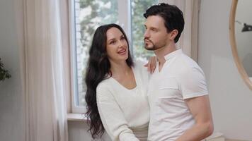 Couple sharing a quiet moment in a cozy room with soft natural light video