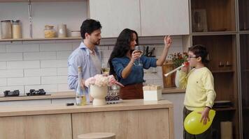 Family gathering in a cozy kitchen with drinks and celebration atmosphere video