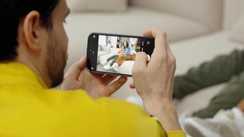 Man captures a cozy moment with a friend at home in the afternoon video