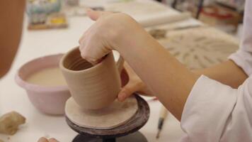 Crafting a clay mug at a local pottery studio in the afternoon video