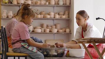 Kids learn pottery skills at a creative workshop in an art studio video