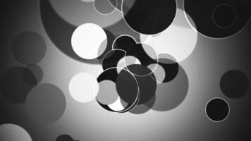 Black and white abstract background with gently moving circle particles and added noise and grain. Full HD and looping motion background animation video