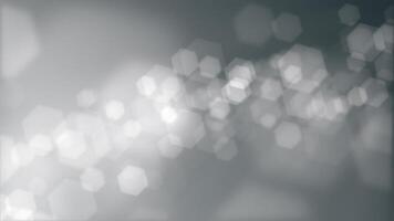 Grayscale bokeh abstract background animation with gently flickering defocused bokeh light hexagons. This elegant atmospheric motion background is full HD and a seamless loop. video