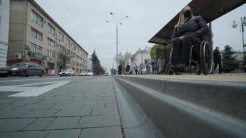 Woman in a wheelchair waiting for a bus at a bus stop 3 video