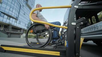 Side view of person using a wheelchair boarding transport using a lift. video