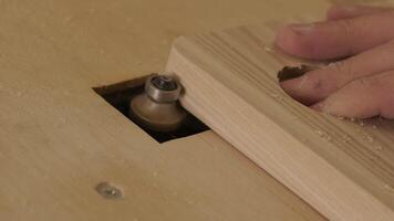 A carpenter uses a router tool for rounding the corner of the wood 2 video