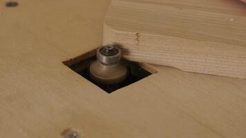 A carpenter uses a router tool for rounding the corner of the wood video