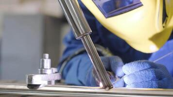 Man wearing mask welding in a workshop. Metal workers use manual labor. Skilled welder. Welder is welding the stainless steel pipes in the factory. welder Industrial part in factory. 7 video