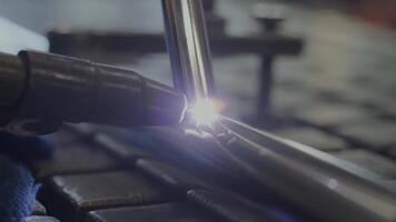 Man wearing mask welding in a workshop. Metal workers use manual labor. Skilled welder. Welder is welding the stainless steel pipes in the factory. welder Industrial part in factory. 8 video