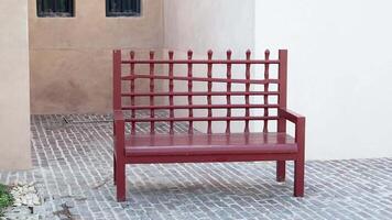 Unique red bench design in quiet courtyard setting video