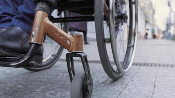 A person with a disability moves along the street in a wheelchair 6 video