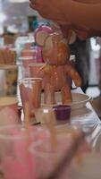 The bear figurine is painted with epoxy liquid resin or brown paint to create an abstract, beautiful, and bright color. Slow motion. video