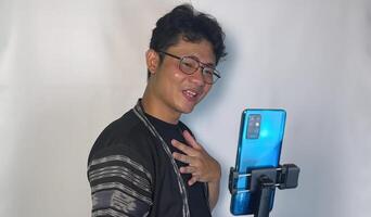 A man holding up a smartphone while smiling video