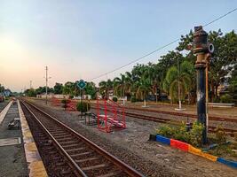Single Train Track at Tulungagung Station at Sunset photo