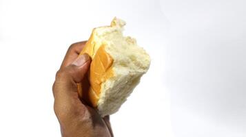 Soft bread in male hand isolated on white background photo