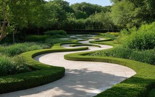 A winding pathway meanders through a beautifully landscaped garden filled with lush greenery. The serene atmosphere invites visitors to enjoy nature's tranquility on a sunny day photo