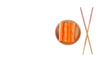 Top view of crab stick or imitation crab meat made from processed fish meat on wooden plate with chopsticks isolated on transparent background png
