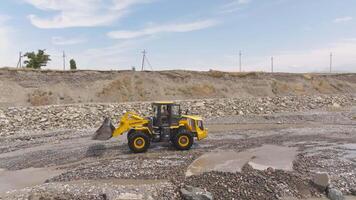 front loader scooping gravel on mountain creek in Sokuluk, Kyrgyzstan - July 3, 2024 video
