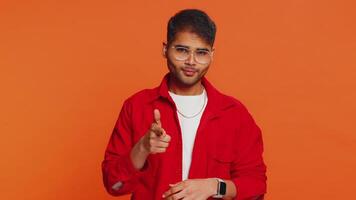 Happy Indian smiling man pointing finger to camera making winner choice, showing direction, select video