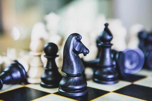 chess table with horse figure in front photo