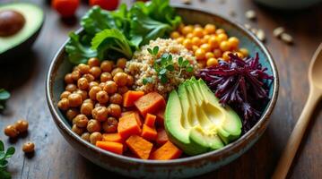 Colorful healthy bowl with quinoa, vegetables, and seeds on a rustic wooden table photo
