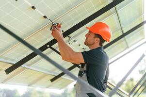 Fixes the, wires.. Man is doing operating and maintenance in solar power plant photo