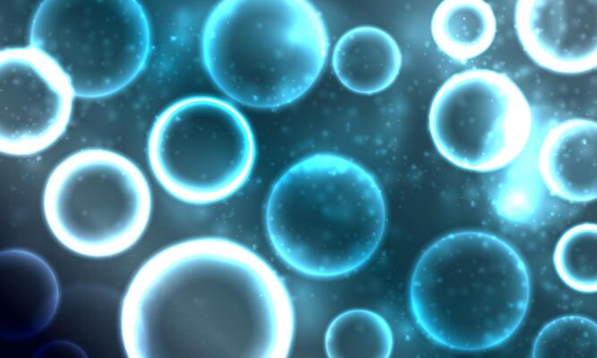 Abstract bokeh circles light blue background.